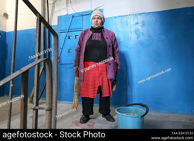 RUSSIA, DONETSK - DECEMBER 2, 2023: A woman is seen in an apartment block damaged in a shelling of the Kirovsky neighbourhood by the Ukrainian Armed Forces