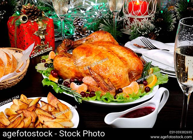 Delicate baked chicken  with an appetizing crust with a citrus garnish on the Christmas table