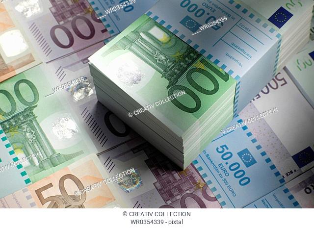 bundles of euro banknotes lined up in rows