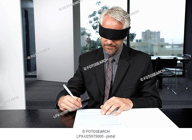 Man signing a contract with eyes closed