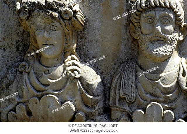 Male and female faces, detail of a stele of Saturn, Roman city of Timgad (Unesco World Heritage List, 1982), Algeria. Roman civilisation