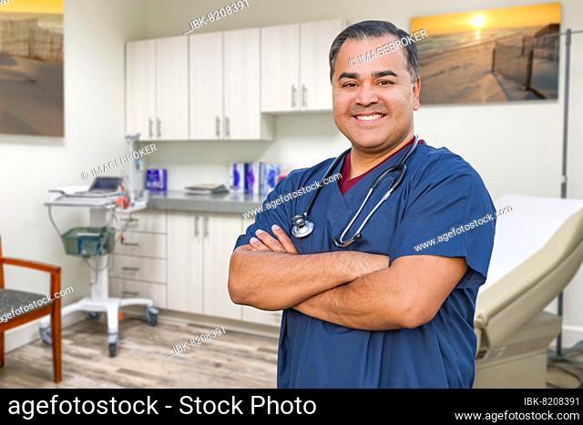 Hispanic male doctor standing in office