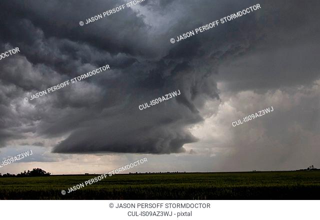 Rotating supercell clouds over field