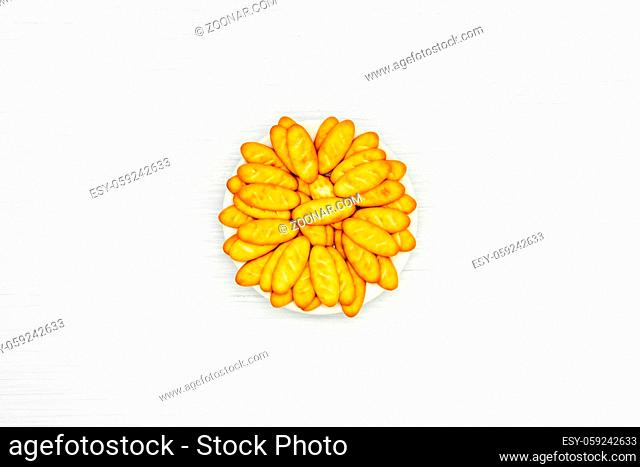 Biscuit crackers in the white plate on wooden background