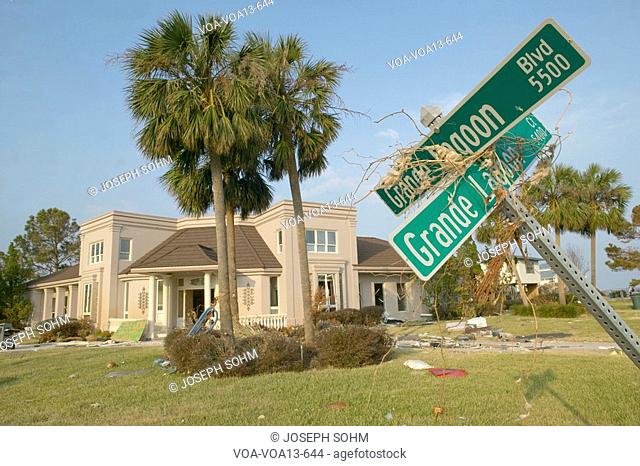 Downed road signs and debris in front of house heavily hit by Hurricane Ivan in Pensacola Florida