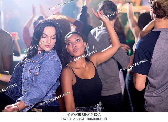 Female friends dancing in nightclub