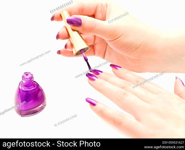 Nail Polish and Woman Hands over White Background