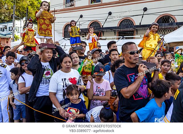 Local People Hold Up Their Santo Nino Statues As The Replica Santo Nino De Cebu Arrives By Sea, The Fluvial Procession, Dinagyang Festival, Iloilo, Panay Island