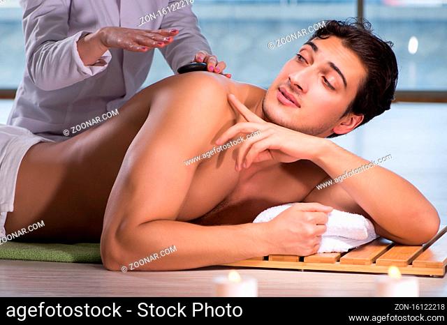 The young handsome man during spa procedure