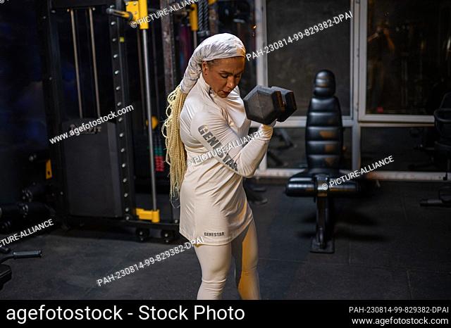 PRODUCTION - 10 August 2023, Iran, Teheran: Sara Mustafanejad, bodybuilder, poses in her gym in the capital Tehran. As one of Iran's few female bodybuilders