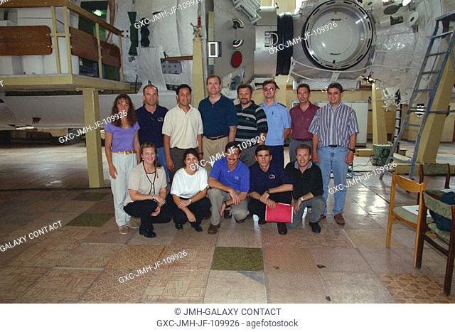 The seven members of the STS-101 crew are joined by their training team for an informal portrait near the Service Module (SM)Functional Cargo Block (FGB) mockup...