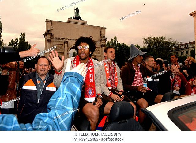 Players of Bayern Munich, Dante (L-R), Rafinha and Luiz Gustavo, celebrate on Leopoldstrasse in Munich, Germany, 12 May 2013
