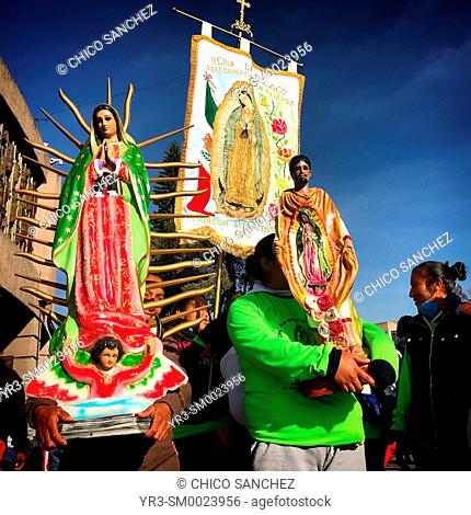 Pilgrims hold images of the Virgin Mary and Saint Juan Diego during the annual pilgrimage to the Our Lady of Guadalupe Basilica in Mexico City, Mexico