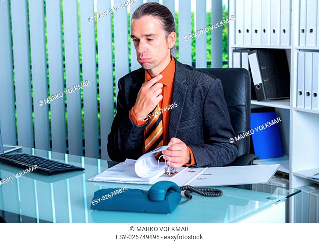 young business man at his desk in summerly hot office