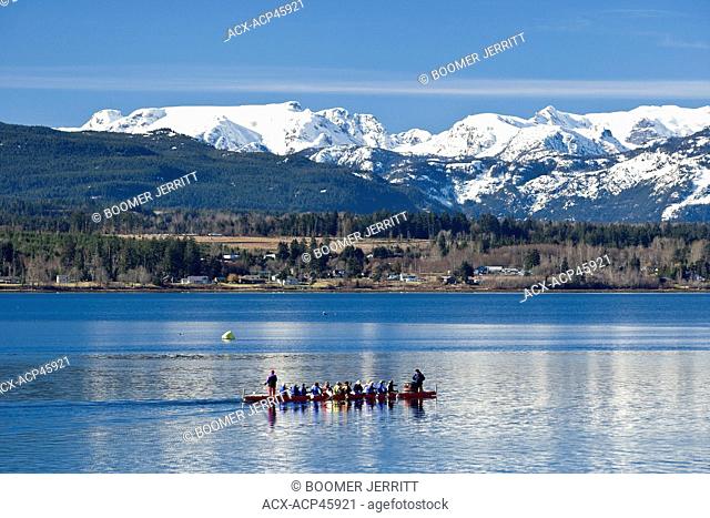 Dragonboater's paddle with the majestic backdrop of the Comox Glacier and Beaufort Mountains, Courtenay, The Comox Valley, Vancouver Island, British Columbia