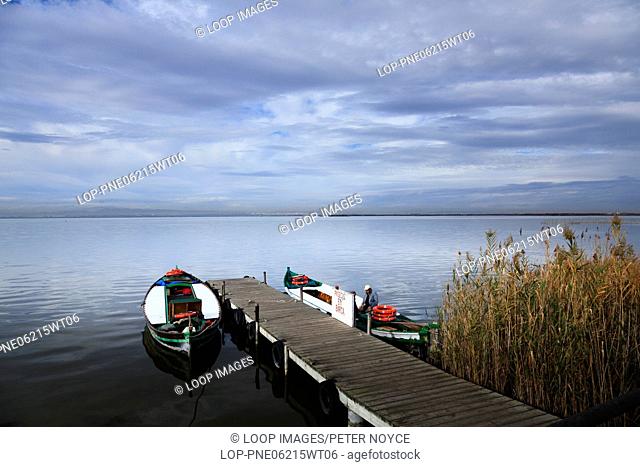 Picturesque view of jetty on Lake Albufera with boats awaiting customers