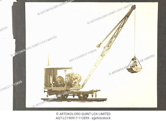 Photograph - A.T. Harman & Sons, Side View of a Rail-Mounted Excavator, circa 1923, A black and white photograph attached to an album page
