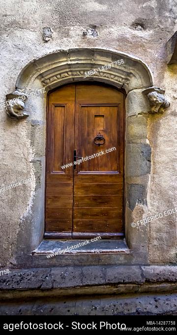 Old front door in Aigne. The old village center has the shape of a snail shell and was built in the 11th century