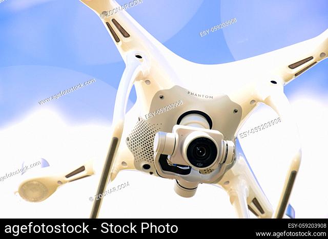 Krasnodar, Russia - May 30, 2017: Drone DJI Phantom 4 in flight. Quadrocopter against the blue sky with white clouds. The flight of the copter in the sky
