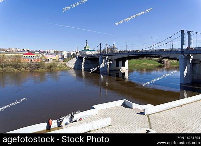 SMOLENSK, RUSSIA - APRIL 23, 2018: A bridge across the Dnieper and fishermen on a partially flooded embankment. The center of Smolensk, Russia