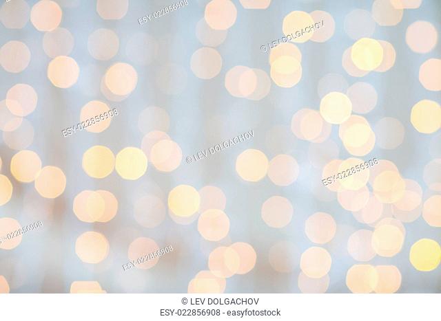 holidays, party and celebration concept - blurred golden lights background