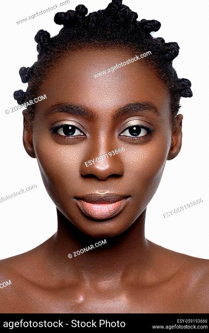 Beautiful young black woman with perfect skin and natural make up. Beauty shot on white background