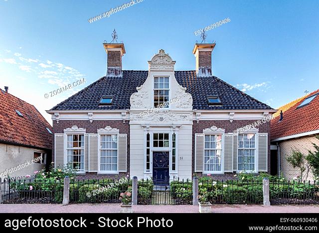 Heeg, Netherlands - August 05, 2020: Ancient house with beautiful decorations in touristic village Heeg in Friesland in the Netherlands
