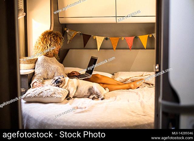 Caravan, woman, bed, lying, laptop, dog, sideways