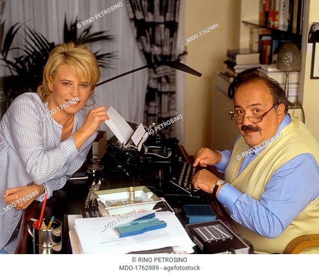 Maurizio Costanzo and Maria De Filippi in front of a typewriter. Italian journalist and TV host Maurizio Costanzo sitting in front of a typewriter beside his...