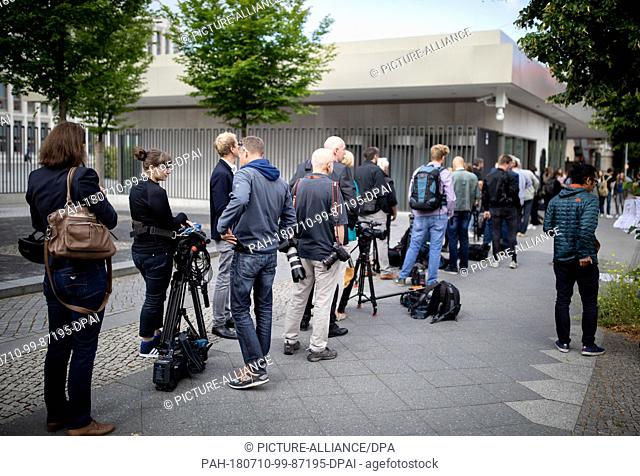 10 July 2018, Germany, Berlin: Several journalists wait for admission to the press conference concerning the presentation of the 'Masterplan Migration' outside...