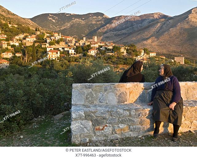 Two villagers chatting in the evening light in the Outer Mani village of Langada, in the the foothills of the Taygetos mountains, Southern Peloponnese, Greece