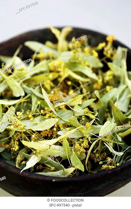 Dried lime flowers in dish close-up