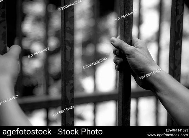 Close up of hands in a prison cell, jail