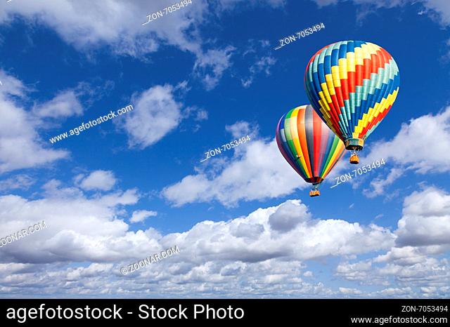Two Hot Air Balloons Up In The Beautiful Blue Sky