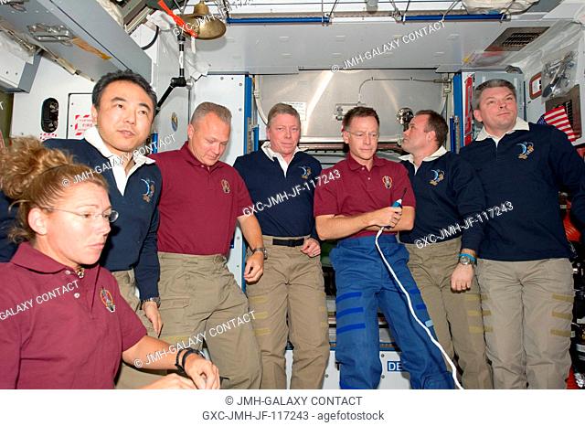 Members of the STS-135 and Expedition 28 crews assemble in the International Space Station's Node 2 or Harmony for a farewell moment