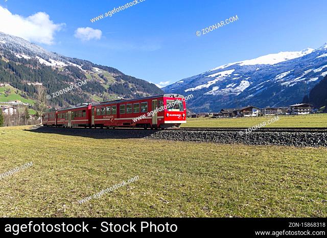 Ziller Valley, Austria - March 8, 2020: Passenger train on the narrow gauge railway in a mountain valley. Sunny day in March