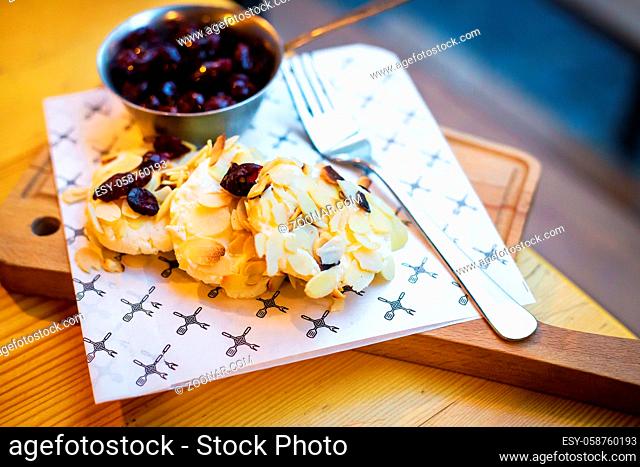 Beautiful presentation Syrnikov sausages with cherry and almond flakes