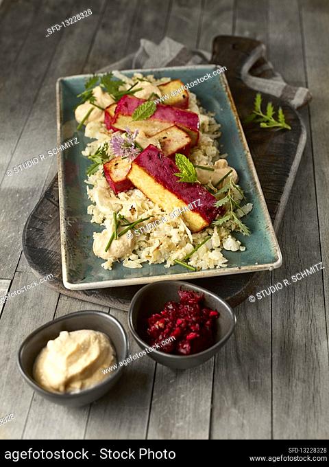 Stir-fried cauliflower and almonds with almond cream and beetroot tofu