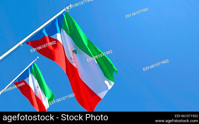 3D rendering of the national flag of Guinea waving in the wind against a blue sky