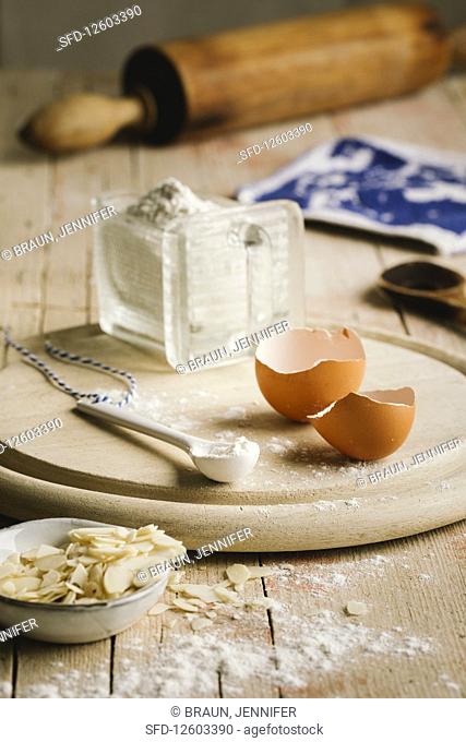 Egg shells, flour, slivered almonds and a rolling pin