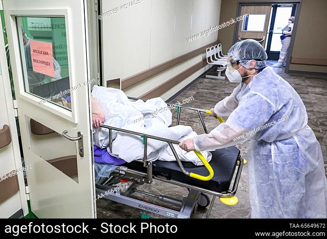 RUSSIA, ST PETERSBURG - DECEMBER 11, 2023: A medical worker delivers a patient to a COVID-19 ward at St George City Hospital