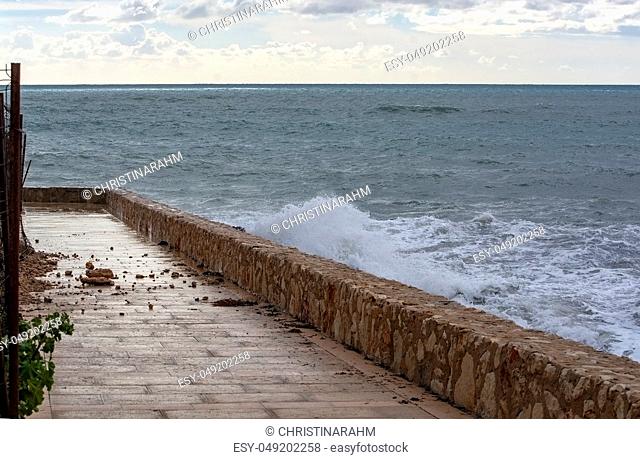 Sea water breaks against rocks and inundates promenade on a stormy winter day in Mallorca, Spain