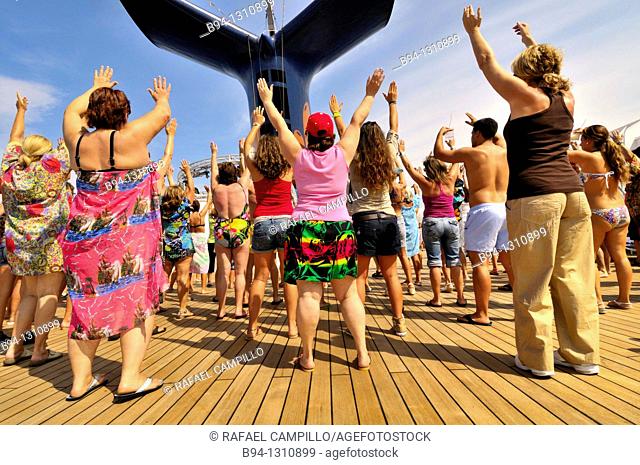 Passengers dancing on the deck of a cruise ship