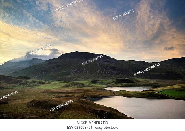 Stunning Summer dawn over mountain range with lake and beautiful