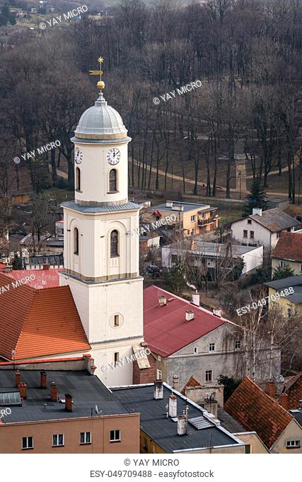 High clock tower of the Saint Jadwiga Catholic church in Bolkow town in Lower Silesia, Poland, as seen from the walls of the Bolkow castle