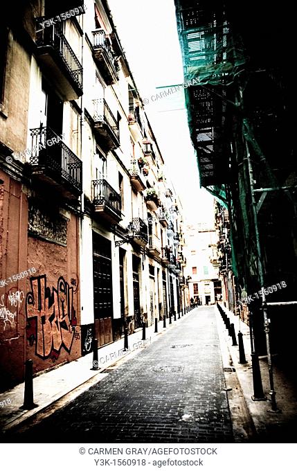 Street in the old area with scaffolding and graffiti. Valencia