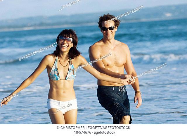 couple walking and sightseeing on beach