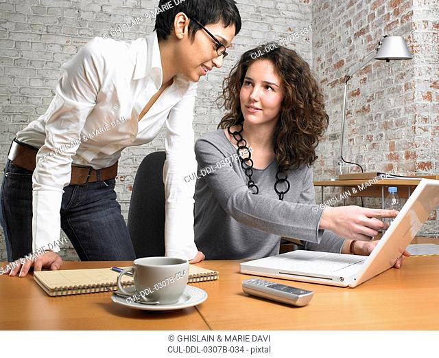 Two businesswomen working on a laptop