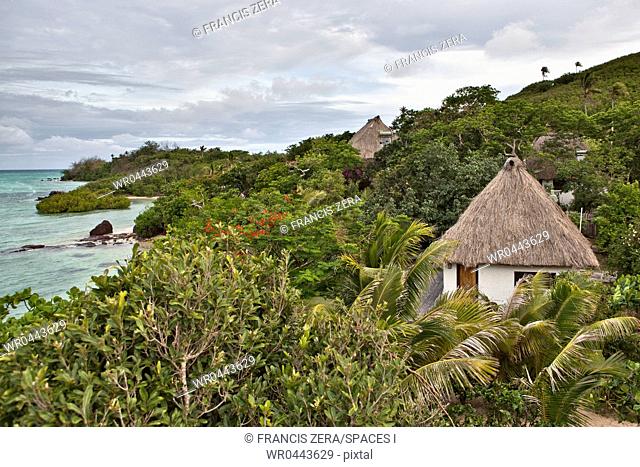 Buildings With Thatched Roofs On Tropical Island