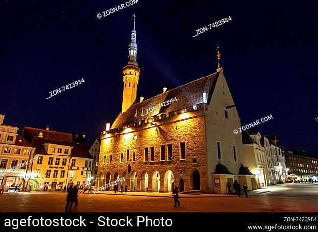 TALLINN, ESTONIA - APRIL 25, 2015 : Front view of medieval Lutheran Church of the Holy Ghost in Tallinn, Estonia, in dark on navy blue sky background